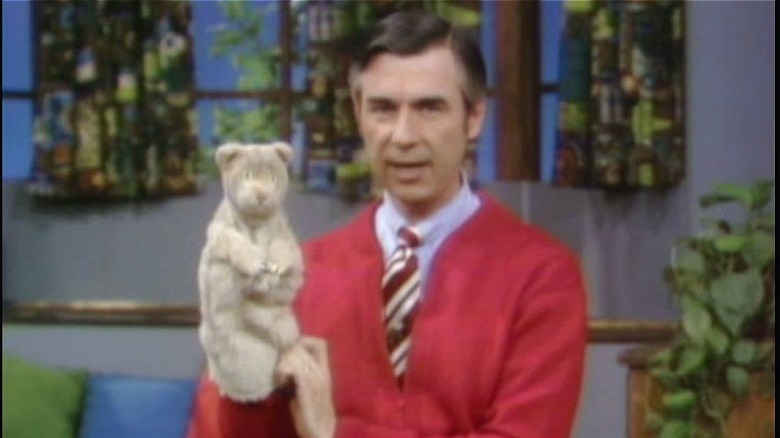 mr. rogers in red sweater with puppet